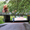 Riding under one of the overpasses into Rembrandt Park with art sitting above