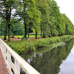 Crossing a wooden, leaving Sloterpark before following a bike path next to a long, straight canal